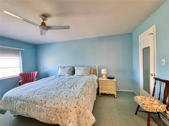 a bed room with a bed and a chair