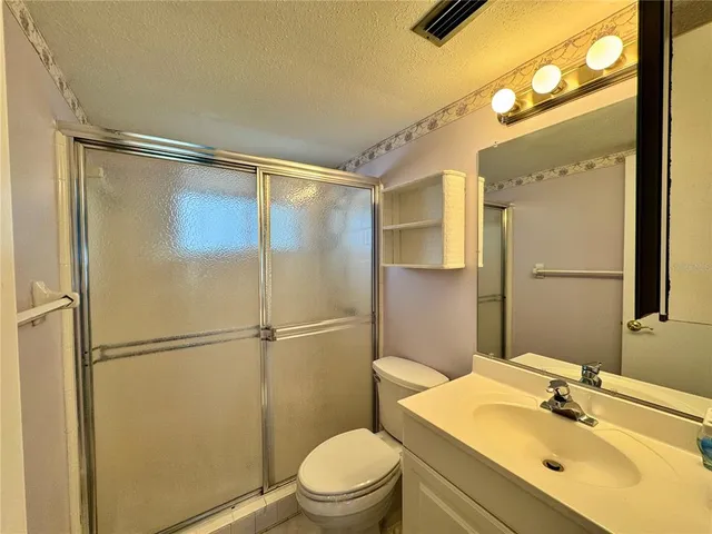 a bathroom with a sink mirror vanity and toilet