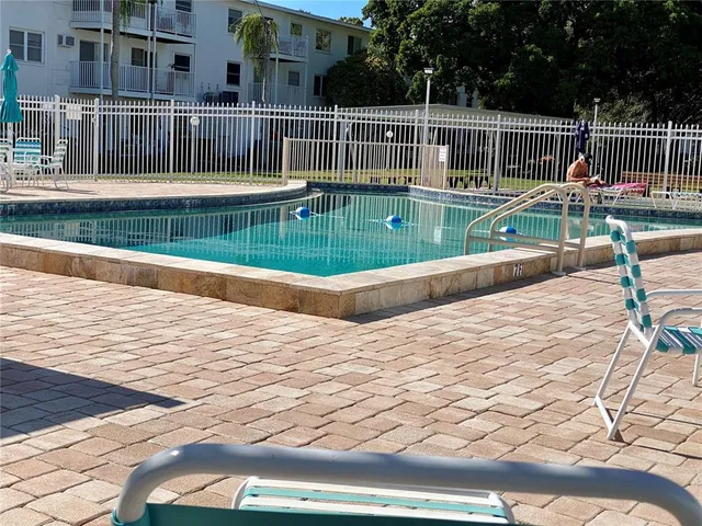 a view of a swimming pool with a yard