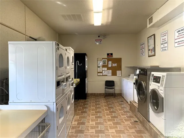 a kitchen with refrigerator a washer and dryer