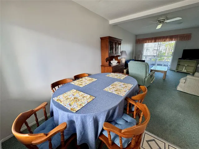 a view of a dining room with furniture and a window