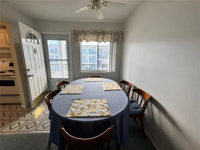 a view of a dining room with furniture and window