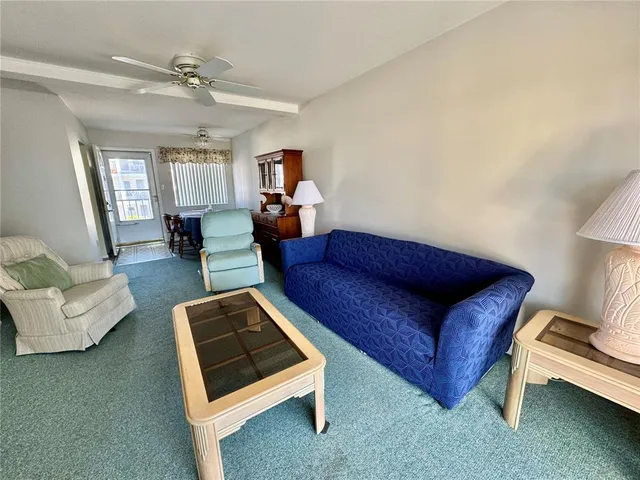 a living room with furniture rug and window