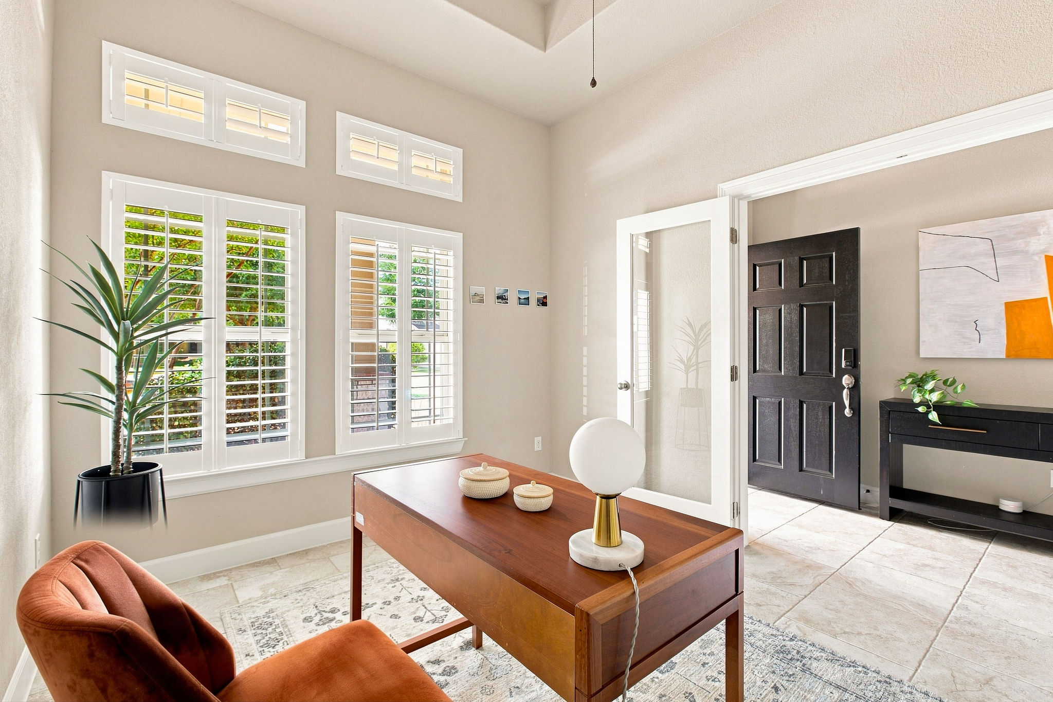 6100 Gunnison Turn Road Austin, TX 78738 - Photo 26 of 34 Double glass doors open into a bright home office featuring tile floors and plantation shutters.