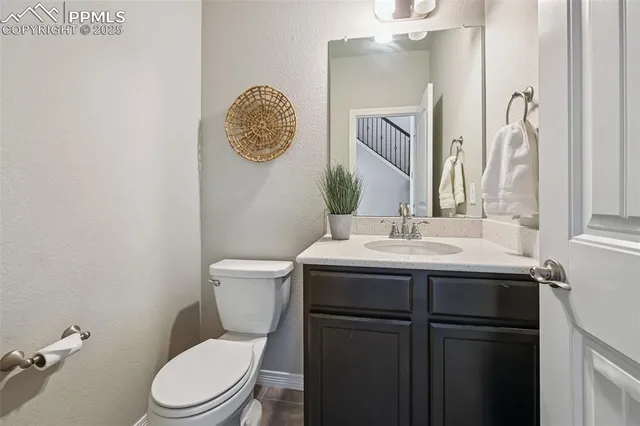 a bathroom with a toilet a sink and mirror