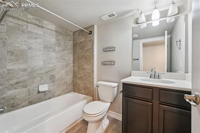 a bathroom with a sink toilet vanity and bathtub