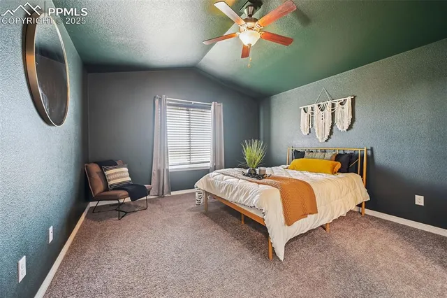 a spacious bedroom with a bed and a chandelier