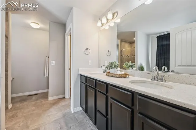 a bathroom with a double vanity sink and a mirror