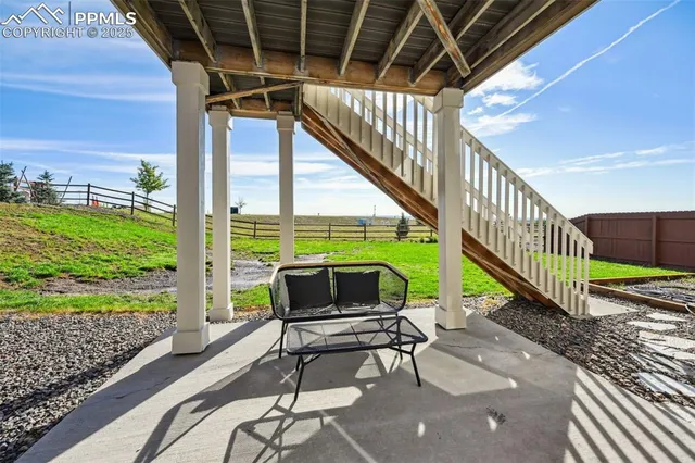a porch with a table and chairs