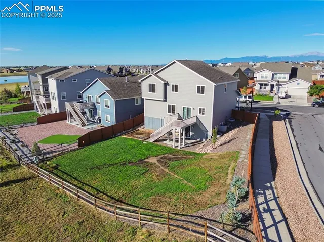 a view of a house with a yard and furniture