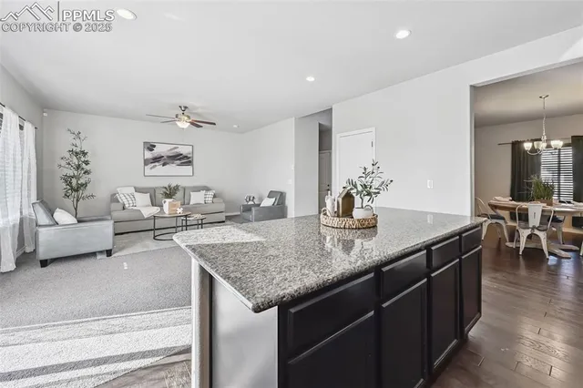 a kitchen with center island table and chairs