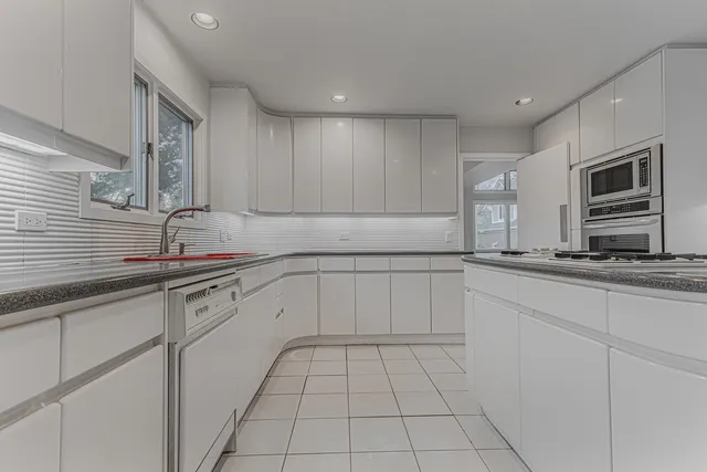 a kitchen with a sink and cabinets