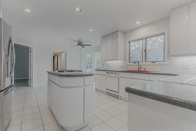 a kitchen with stainless steel appliances a sink stove and cabinets