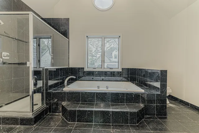 a bathroom with a bathtub and window