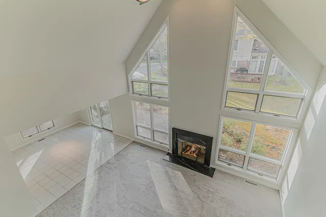 a view of a livingroom with wooden floor and windows