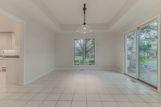 an empty room with windows and outdoor view