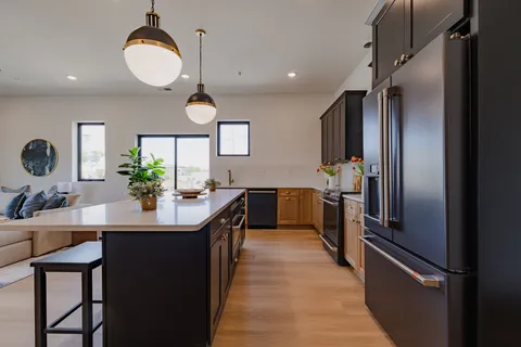 a kitchen with a stove a sink and a refrigerator
