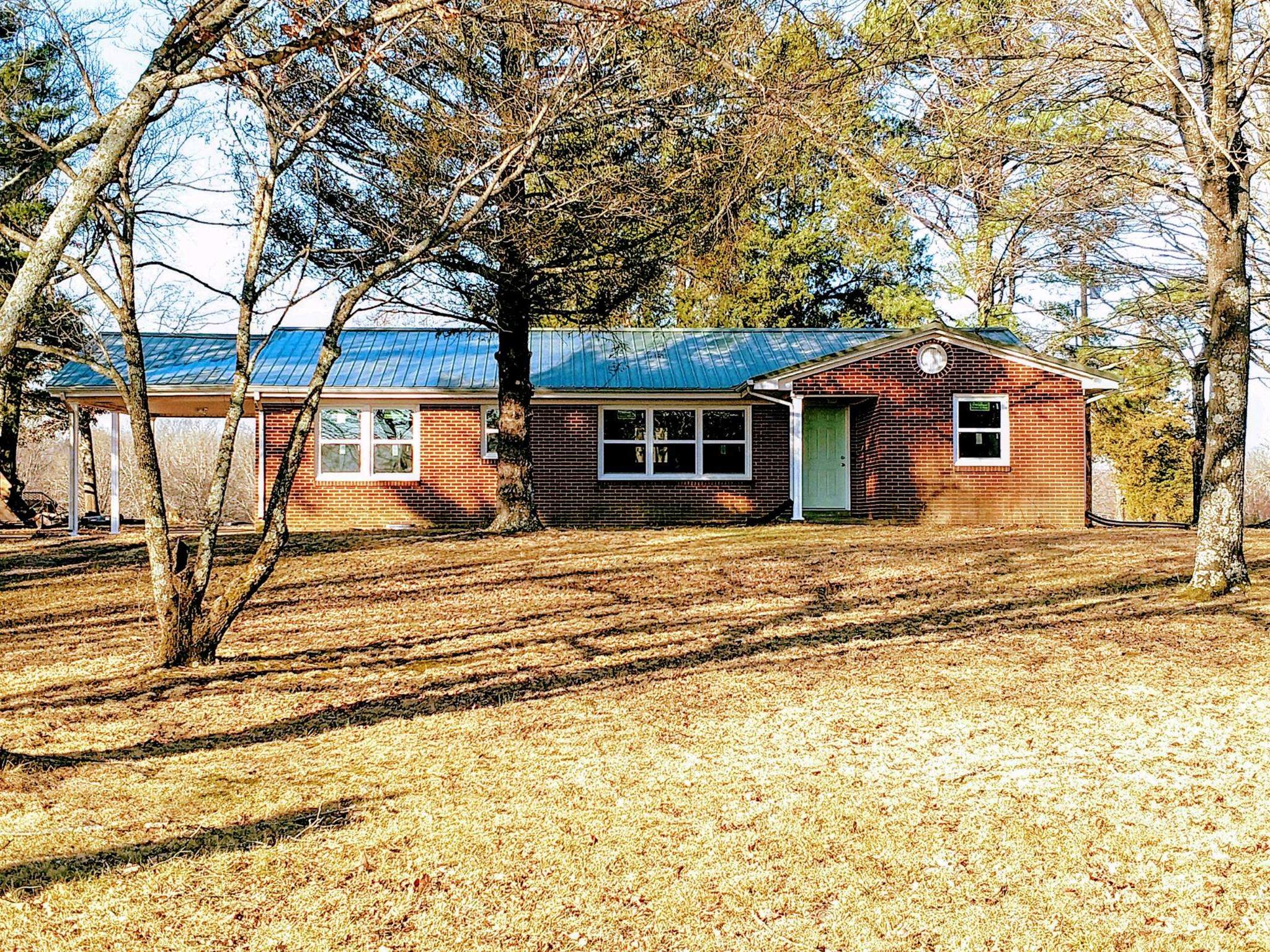 397 Lone Star Road Lawrenceburg, TN 38464 - Photo 1 of 13 a front view of a house with a garden