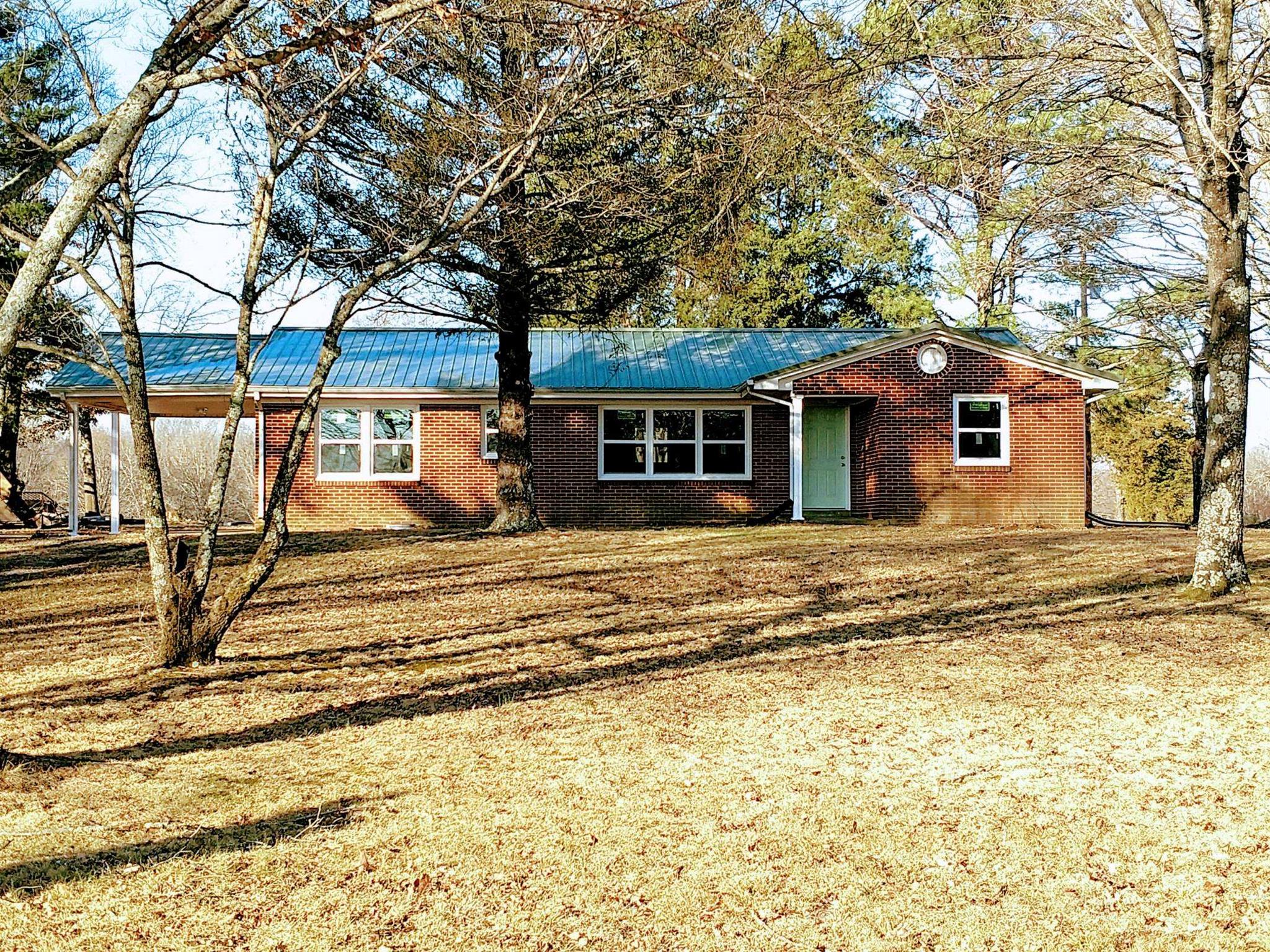 397 Lone Star Road Lawrenceburg, TN 38464 - Photo 13 of 13 a front view of a house with a garden