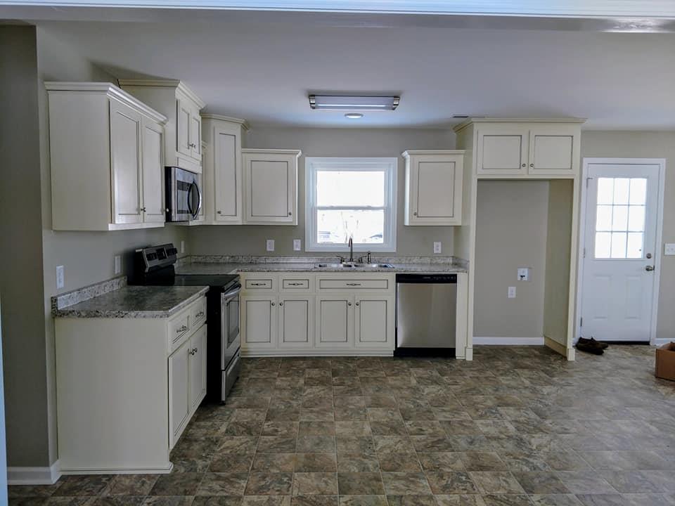 397 Lone Star Road Lawrenceburg, TN 38464 - Photo 5 of 13 a kitchen with granite countertop a sink cabinets and window