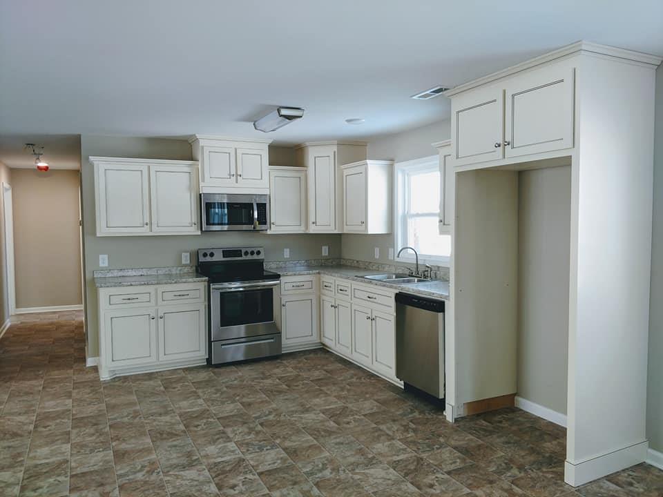397 Lone Star Road Lawrenceburg, TN 38464 - Photo 6 of 13 a kitchen with granite countertop white cabinets and stainless steel appliances