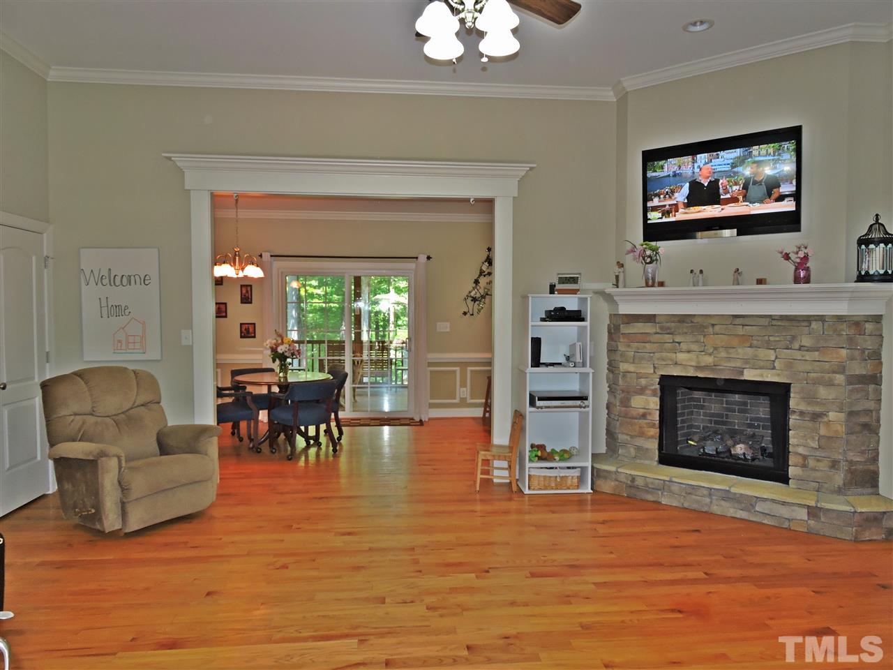 174 Weaver Ridge Road Rougemont, NC 27572 - Photo 2 of 25 a living room with furniture a flat screen tv and a fireplace
