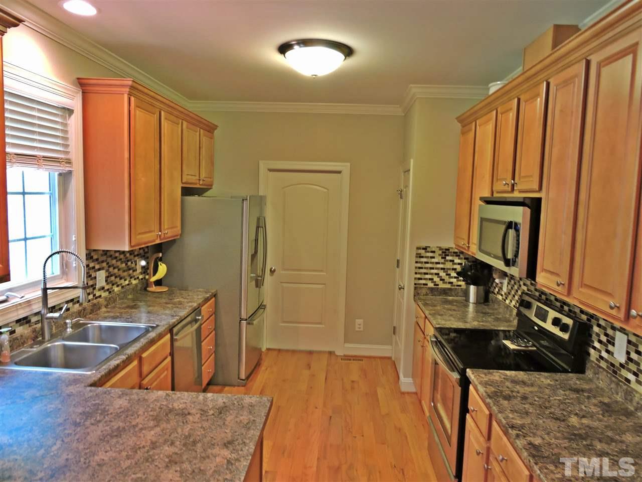 174 Weaver Ridge Road Rougemont, NC 27572 - Photo 11 of 25 a kitchen with stainless steel appliances granite countertop a sink stove and cabinets