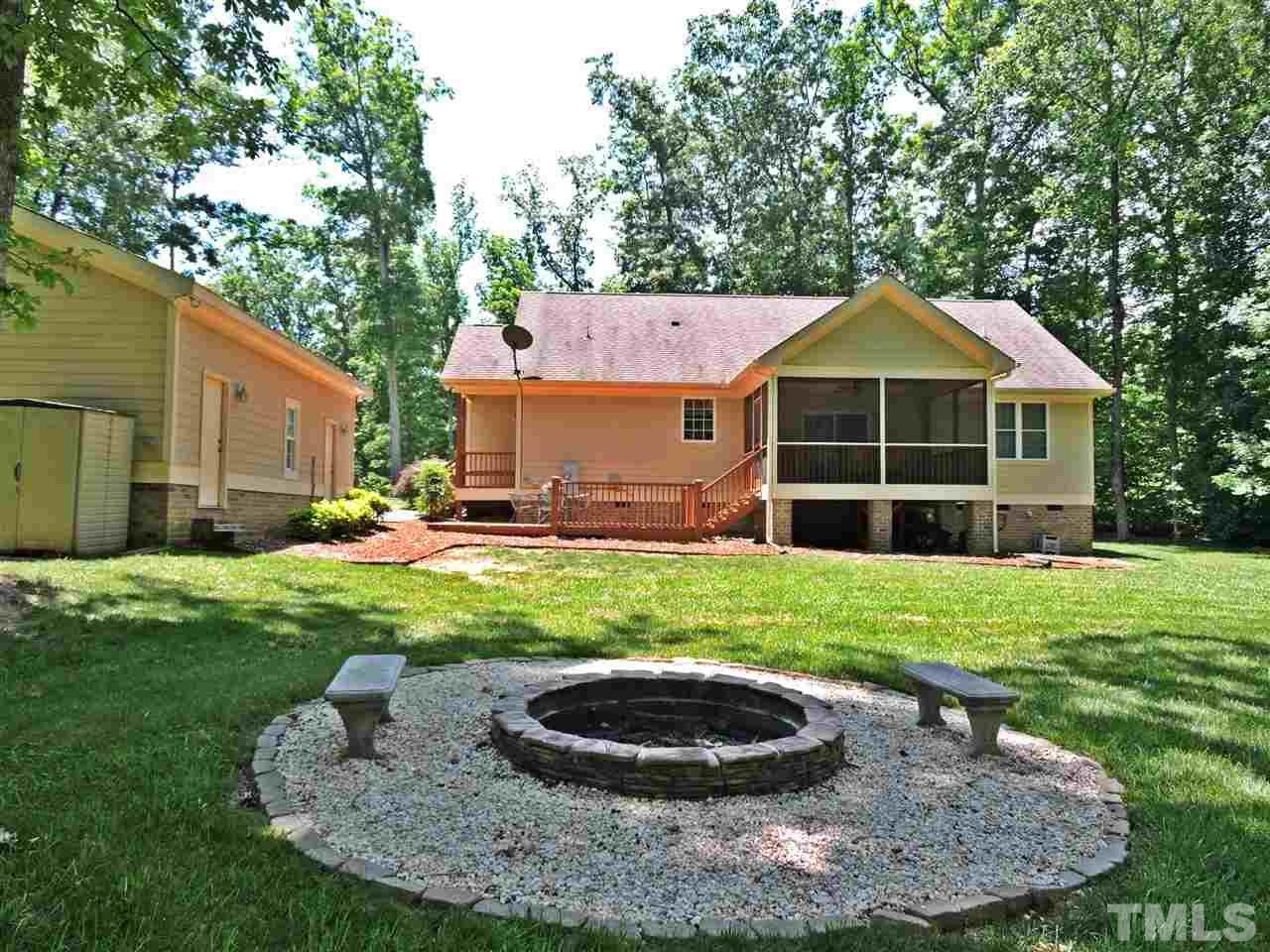 174 Weaver Ridge Road Rougemont, NC 27572 - Photo 8 of 25 a view of a backyard with table and chairs and a grill