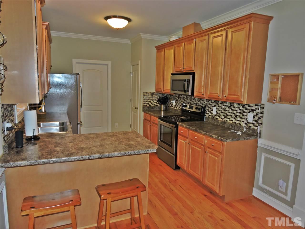 174 Weaver Ridge Road Rougemont, NC 27572 - Photo 10 of 25 a kitchen with granite countertop a sink stove and cabinets