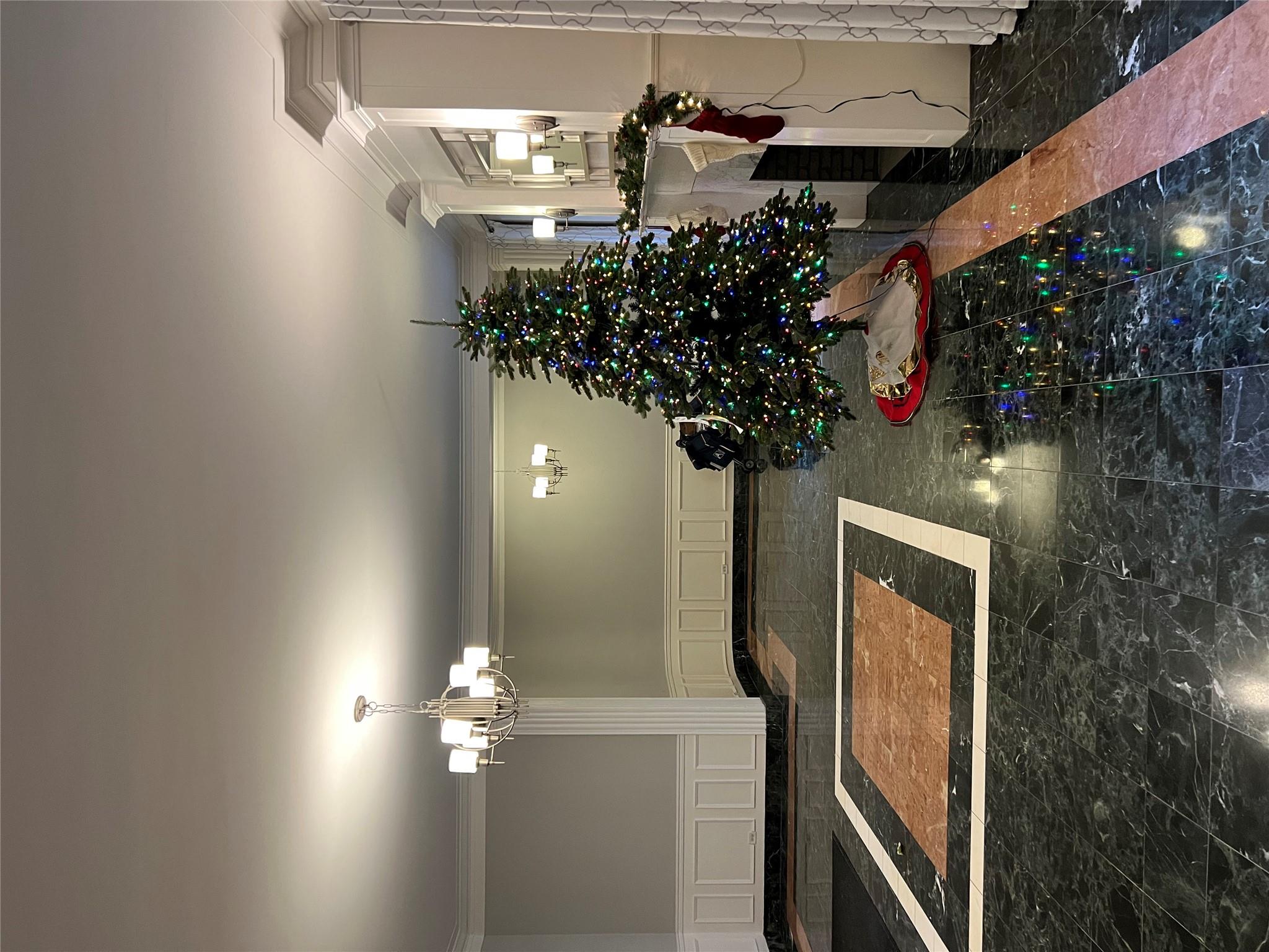 35-35 75th Street, Unit 127 Queens, NY 11372 - Photo 13 of 50 Unfurnished dining area featuring an inviting chandelier and crown molding