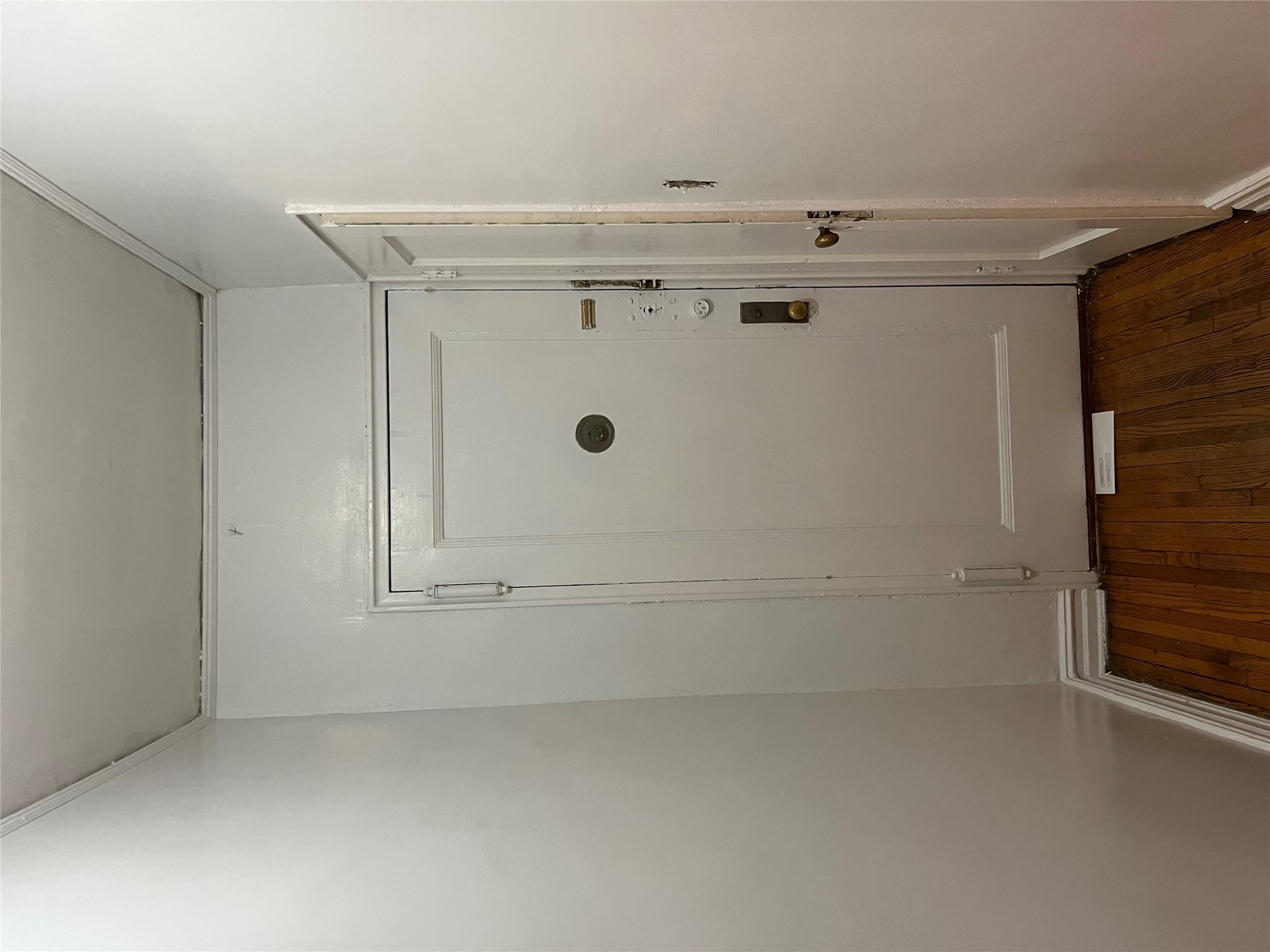 35-35 75th Street, Unit 127 Queens, NY 11372 - Photo 20 of 50 Doorway to outside with dark hardwood / wood-style flooring