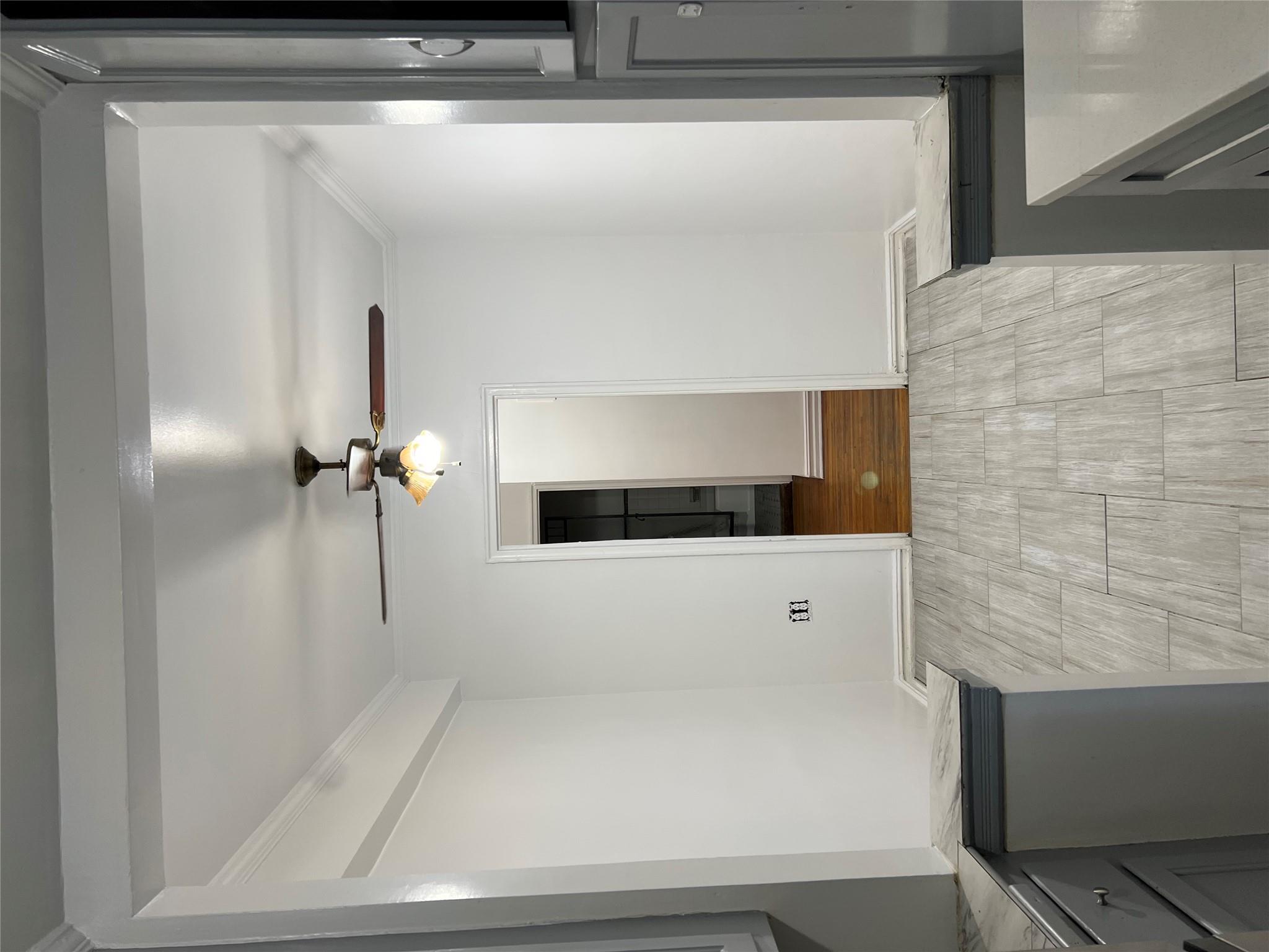 35-35 75th Street, Unit 127 Queens, NY 11372 - Photo 23 of 50 Laundry area with ceiling fan, ornamental molding, and light wood-type flooring