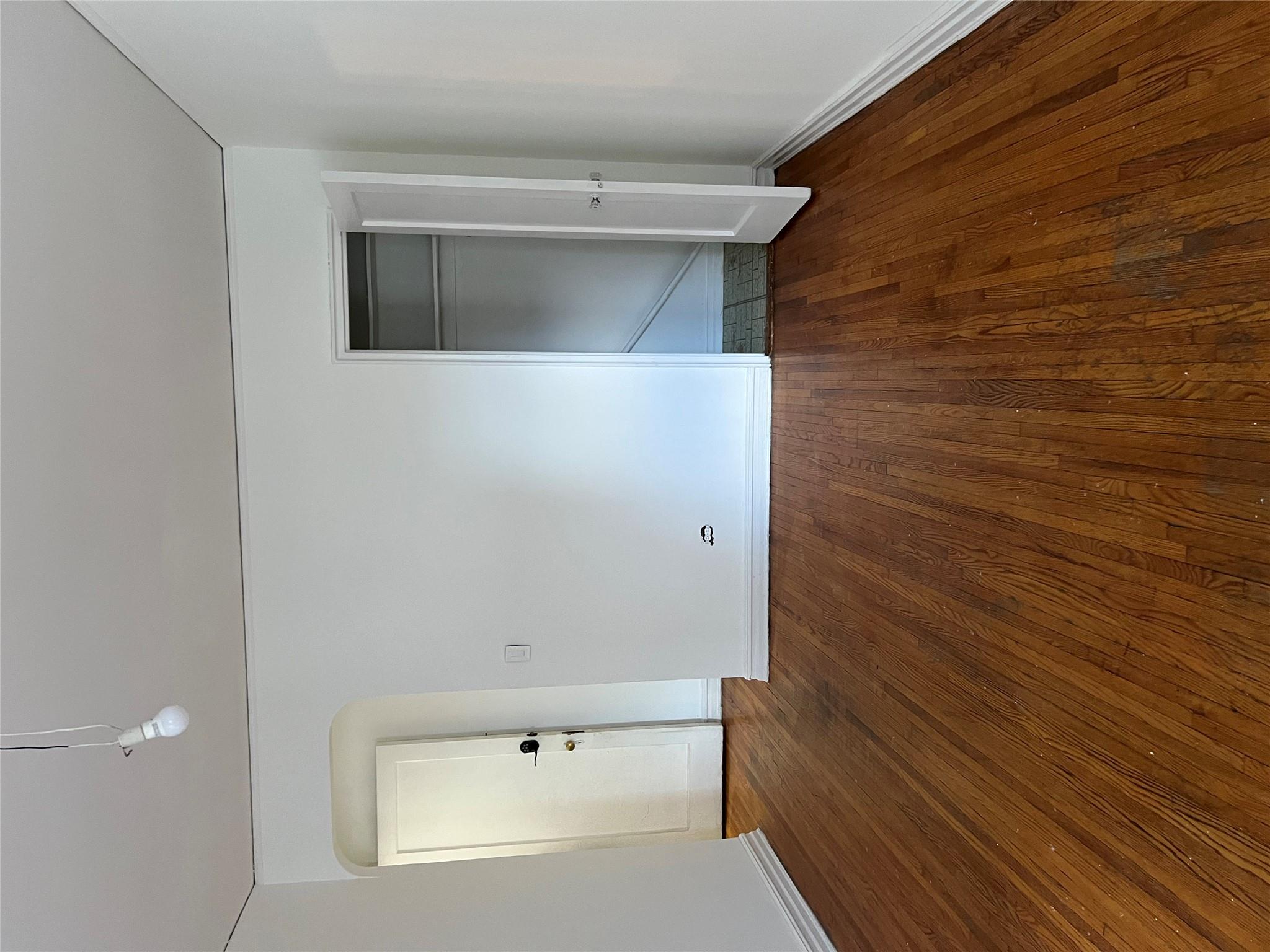 35-35 75th Street, Unit 127 Queens, NY 11372 - Photo 32 of 50 Unfurnished bedroom featuring dark hardwood / wood-style flooring