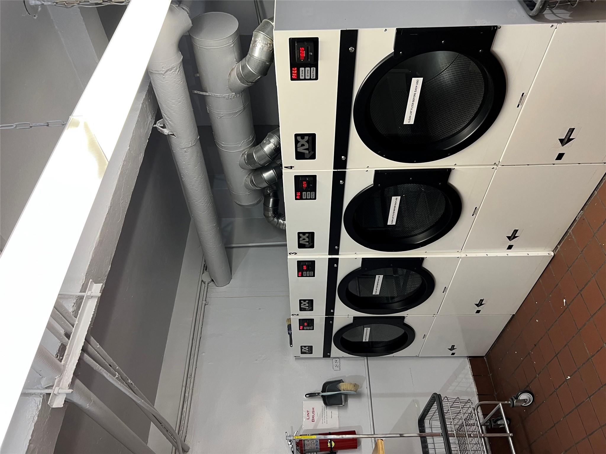 35-35 75th Street, Unit 127 Queens, NY 11372 - Photo 43 of 50 Clothes washing area featuring separate washer and dryer and dark tile patterned floors