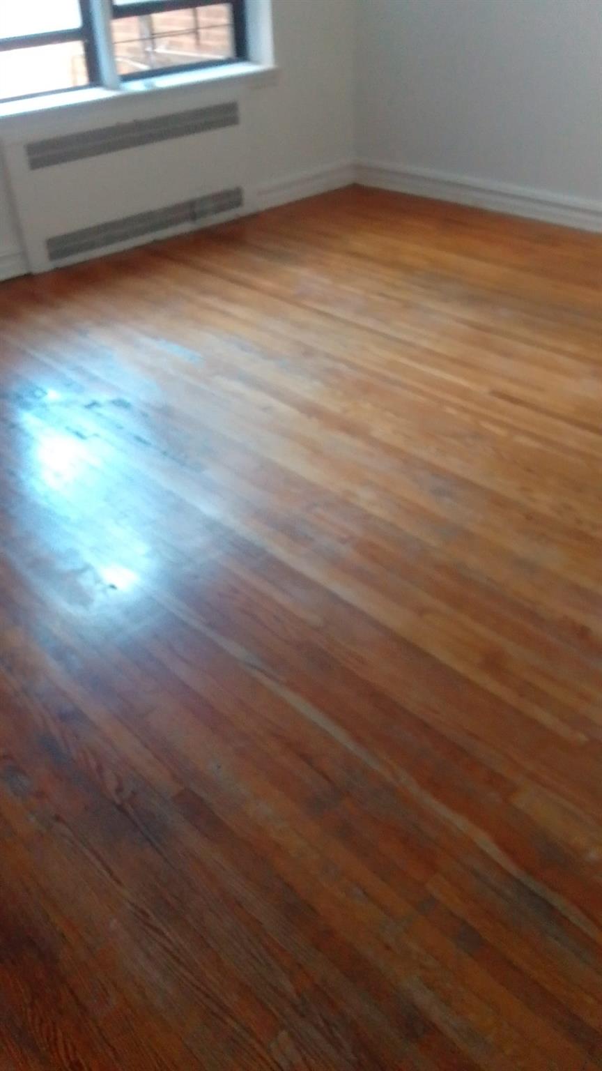 35-35 75th Street, Unit 127 Queens, NY 11372 - Photo 50 of 50 Spare room with wood-type flooring and a baseboard heating unit