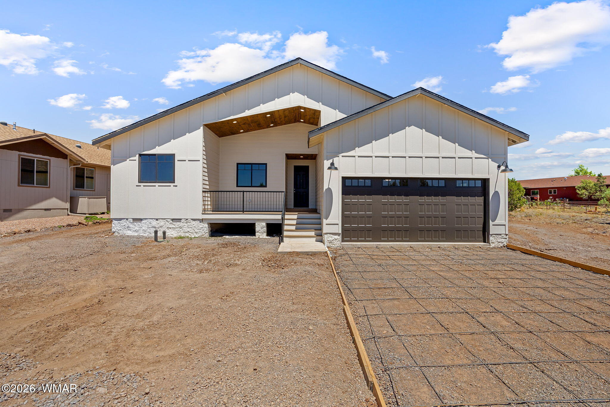 561 South Rock Ridge Drive Show Low, AZ 85901 - Photo 24 of 28 a front view of a house with a yard and garage