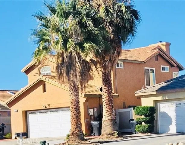 a front view of a house with a tree