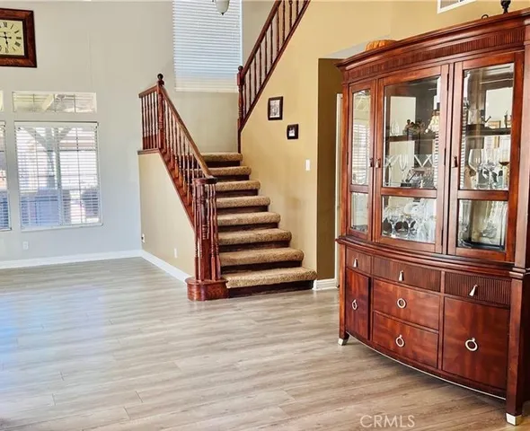 a view of an entryway with wooden floor and stairs