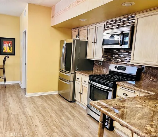 a kitchen with a sink stove and refrigerator