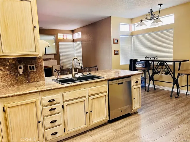 a kitchen with stainless steel appliances granite countertop a stove and white cabinets
