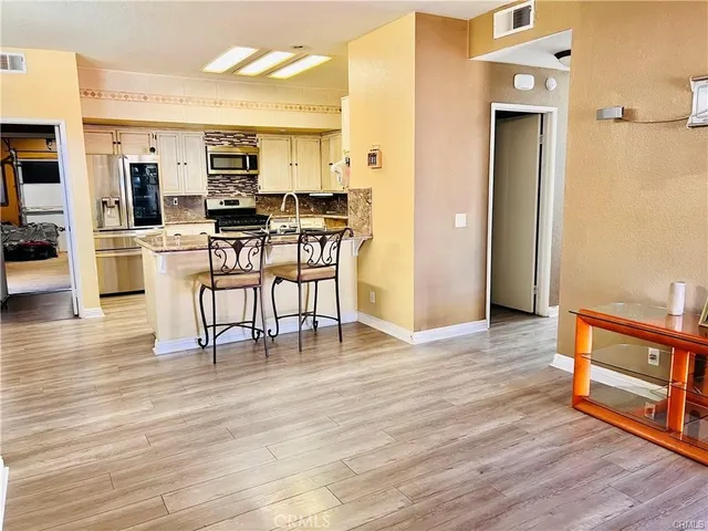 a view of kitchen with cabinets and wooden floor