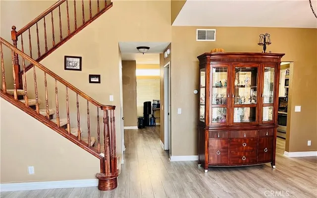 a view of entryway and hall with wooden floor