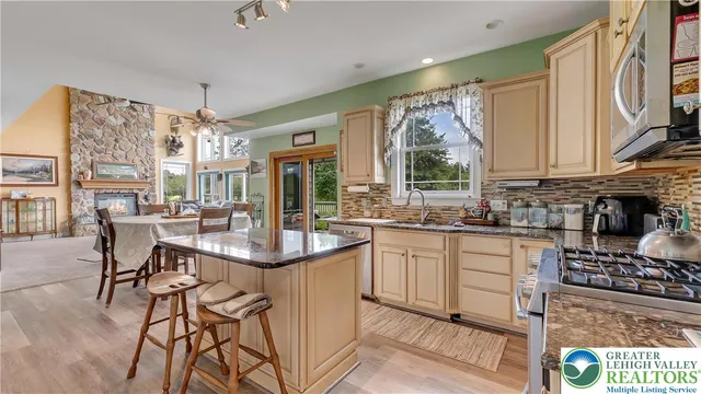 a kitchen with stainless steel appliances granite countertop a refrigerator and a stove top oven
