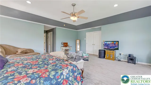 a bedroom with a bed and a chandelier