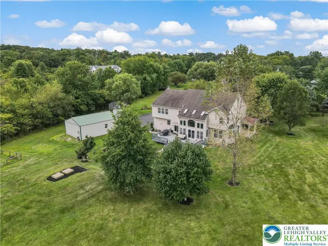 a view of a house with a yard and deck