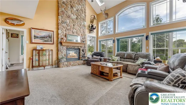 a kitchen with stainless steel appliances granite countertop a stove a sink dishwasher and white cabinets with wooden floor