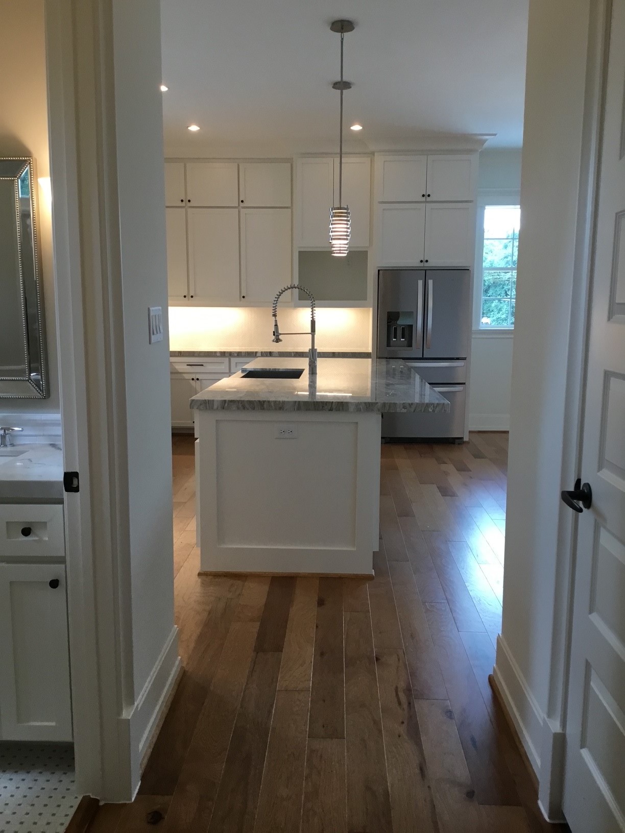 1116 Bartlett Street, Unit B Houston, TX 77006 - Photo 3 of 22 a kitchen with stainless steel appliances granite countertop a refrigerator a sink dishwasher a stove and a dining table with wooden floor