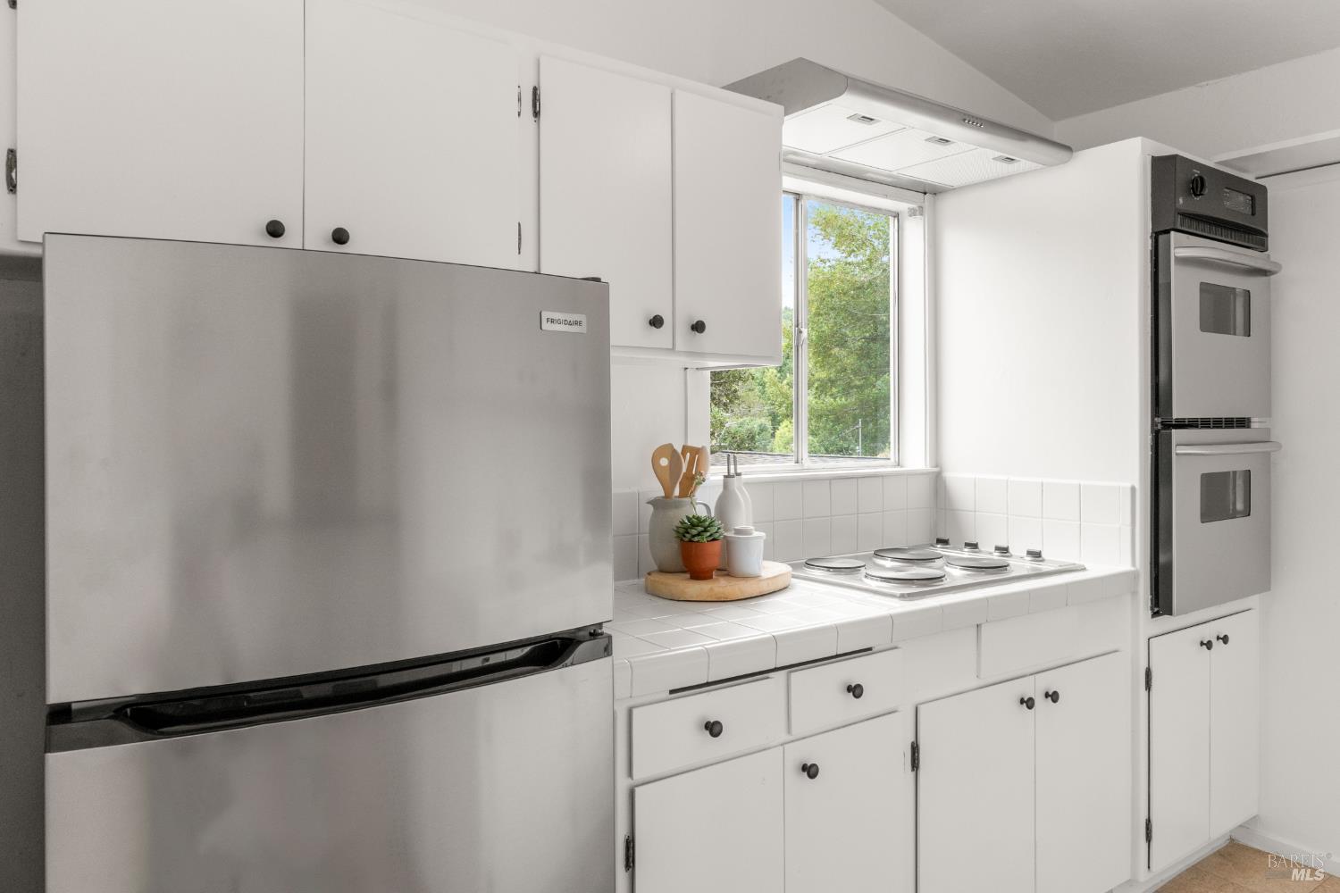 206 Bolinas Road Fairfax, CA 94930 - Photo 10 of 43 The kitchen features new stainless fridge, double oven, range hood and cooktop.