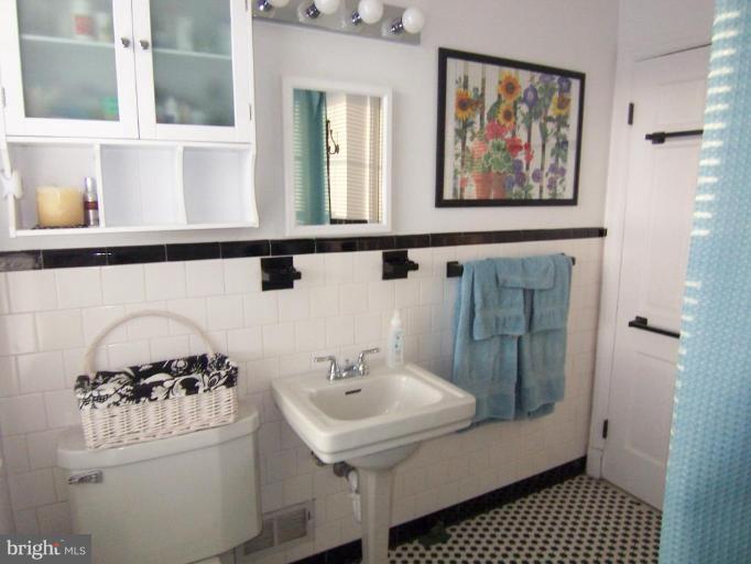 331 Stratford Road Catonsville, MD 21228 - Photo 3 of 30 a bathroom with a sink and a mirror