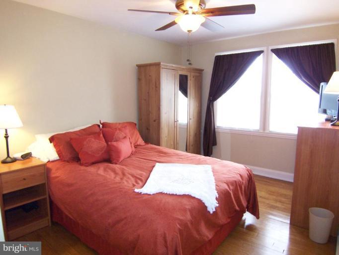 331 Stratford Road Catonsville, MD 21228 - Photo 5 of 30 a bedroom with a bed and a chandelier